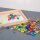 Set with 144 colorful, translucent plastic gems in a storage box